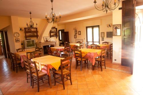 a restaurant with tables and chairs in a room at Agriturismo Petrilli in Flumeri