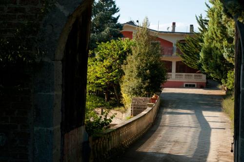 a building with a fence next to a street at Agriturismo Petrilli in Flumeri