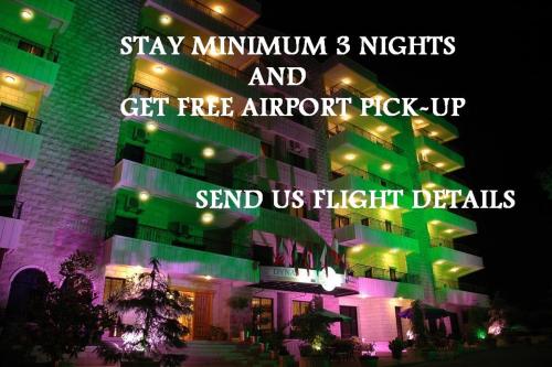 a building with colorful lights on it at night at Dynasty Suite in Aley
