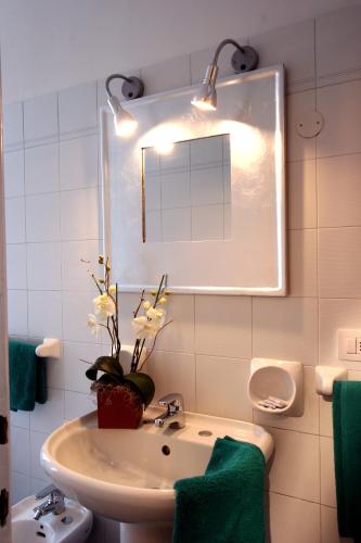 a bathroom with a sink and a mirror at Residence Pian della Nave in Milan