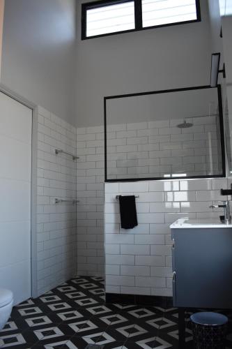 a bathroom with a sink and a toilet at Ironbark House in Dimbulah