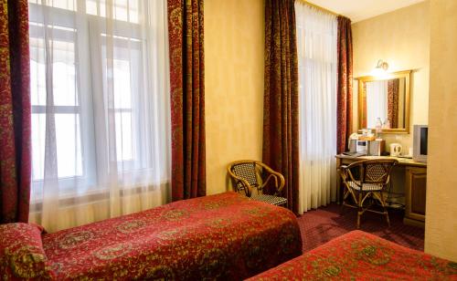 Postel nebo postele na pokoji v ubytování Boutique Hotel Monte Kristo