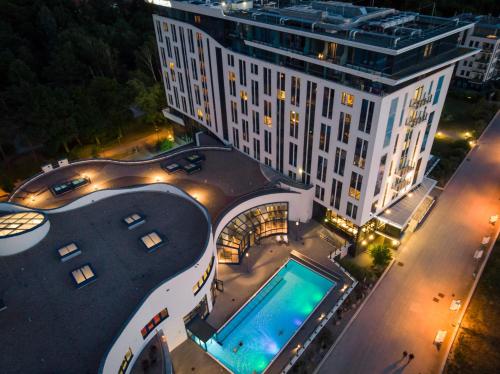 an aerial view of a building with a swimming pool at aja Warnemünde in Warnemünde