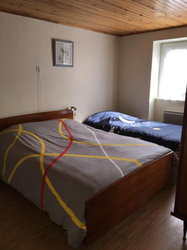 a bedroom with a bed with a yellow cord on it at Maison à Font-Romeu - Odeillo in Odeillo-Via