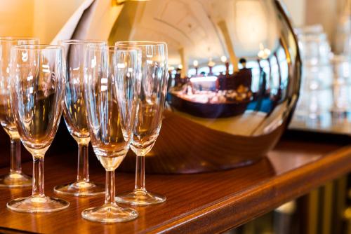 a group of wine glasses sitting on a counter at Strandhotel Ostfriesenhof in Borkum