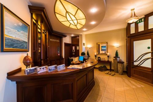 a lobby with a reception desk in a building at Strandhotel Ostfriesenhof in Borkum
