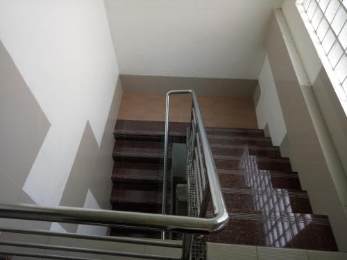 an escalator in a building with a staircase at BnT Inn in Mactan