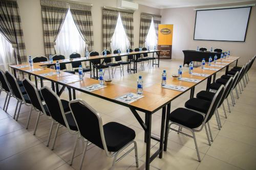 a large conference room with a long table and chairs at Ngwenya Hotel & Conference Centre in Klerksdorp
