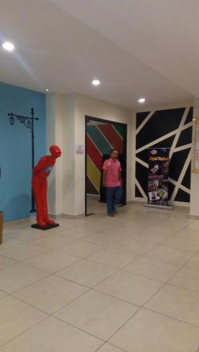 a room with a statue of a person in a store at ZamLan Gold Coast Morib Intl Resort - Studio in Banting