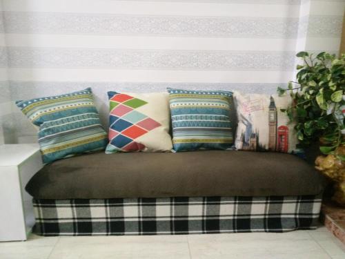 a bench with pillows on it in a room at Forelsket 2 in Da Lat