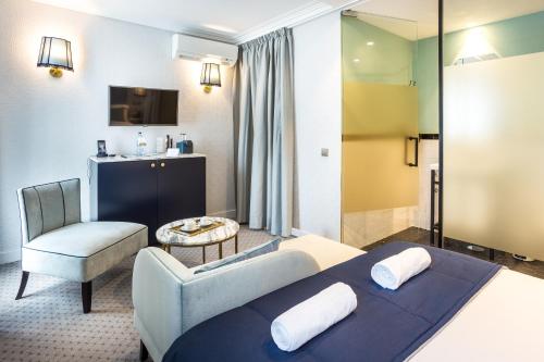 a hotel room with a bed and a chair at The Lift Boutique Hotel by RIDAN Hotels in Lisbon
