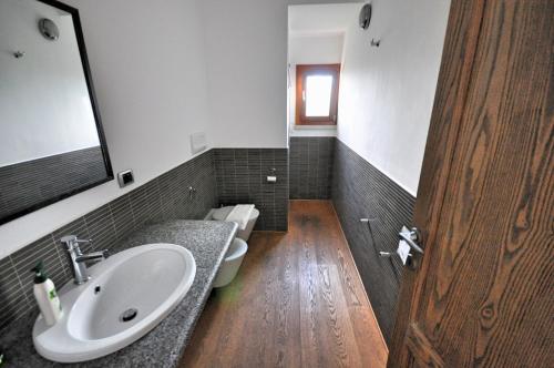 a bathroom with a sink and a toilet at Capannizza Villas in Budoni