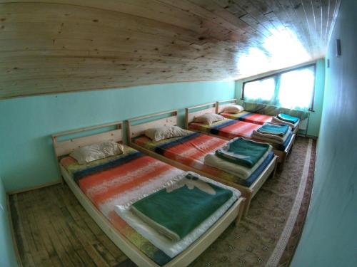 a room with three bunk beds in a house at хижа "Скакавица" in Panichishte