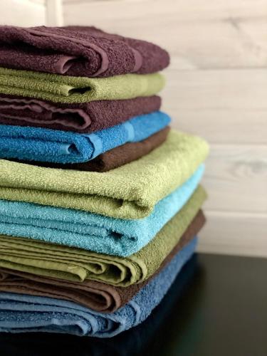 a pile of towels stacked on top of each other at Guest House Mr Fox in Druskininkai