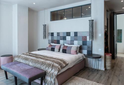 a bedroom with a large bed and a window at Latitude 15 Degrees in Lusaka