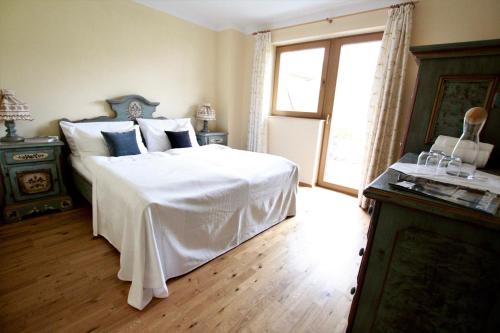a bedroom with a white bed and a window at Chalet Melodie in Ehrwald