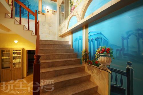 a staircase in a building with a painting on the wall at Happy Inn in Yuchi