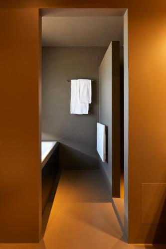 a small bathroom with a towel hanging on the wall at Delparco Hotel in Buttrio