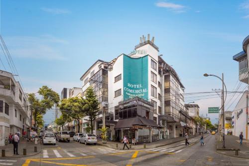 a city street with cars and people crossing the street at Ayenda 1120 Hotel Comercial in Pereira