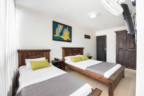 En eller flere senge i et værelse på Ayenda 1120 Hotel Comercial