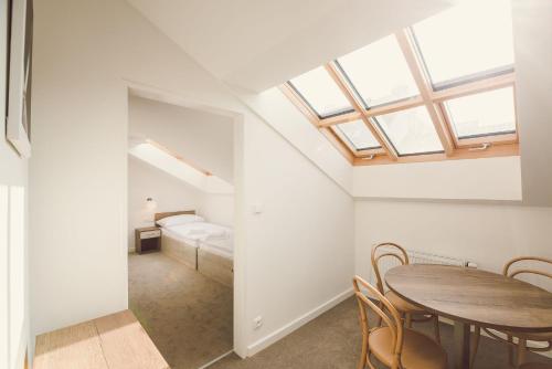 a room with a table and chairs and a bedroom at Kings Residence in Prague