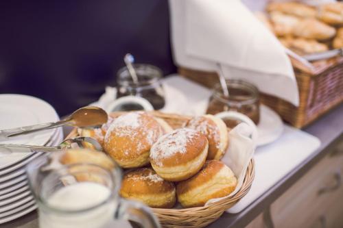 a basket of donuts sitting on a counter top at Kings Residence in Prague