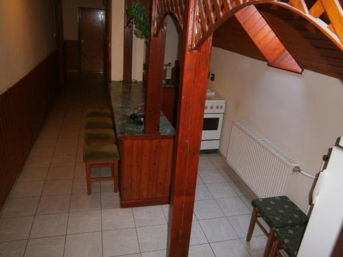 a hallway of a kitchen with a table and chairs at Vándor Vigadó in Zalaegerszeg