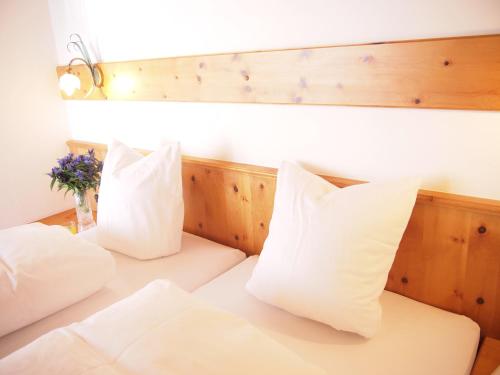 a bedroom with two beds with white pillows at Haus Musella in Samnaun