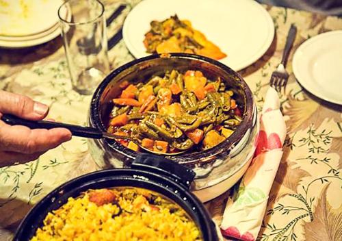 a table with a pan of food on a table at Chicago Group of Houseboats in Srinagar