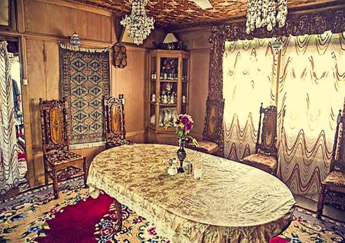 a large room with a table with flowers on it at Chicago Group of Houseboats in Srinagar