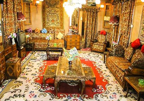 a living room with a couch and a table at Chicago Group of Houseboats in Srinagar