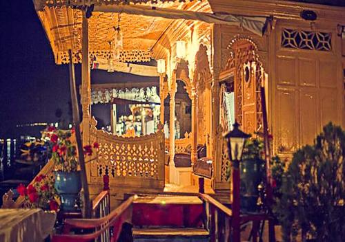 a building with a restaurant with flowers in front of it at Chicago Group of Houseboats in Srinagar