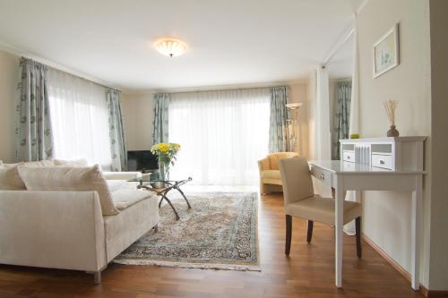 a living room with a couch and a table at Balance Revital-Hotel in Badenweiler