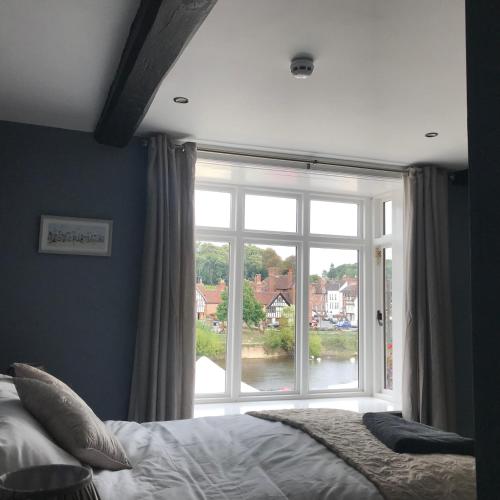 a bedroom with a bed and a large window at The Courtyard in Bewdley