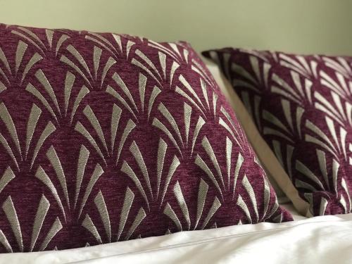 two pillows sitting on top of a bed at The Courtyard in Bewdley