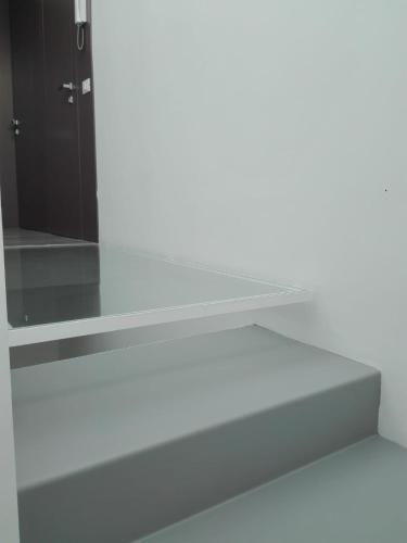 a white shelf in a room with a black door at Patio 101 "Exclusive" in San Vito lo Capo