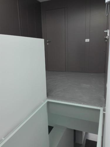 an empty room with a glass table and a door at Patio 101 "Exclusive" in San Vito lo Capo