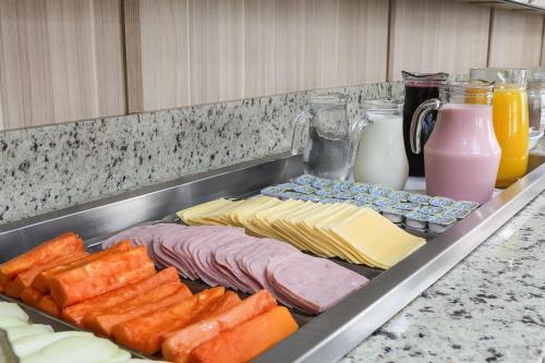 a tray of different types of meats and cheese at Hotel Express Centro Histórico in Porto Alegre