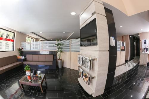 a lobby with a couch and a table in a building at Hotel Express Centro Histórico in Porto Alegre