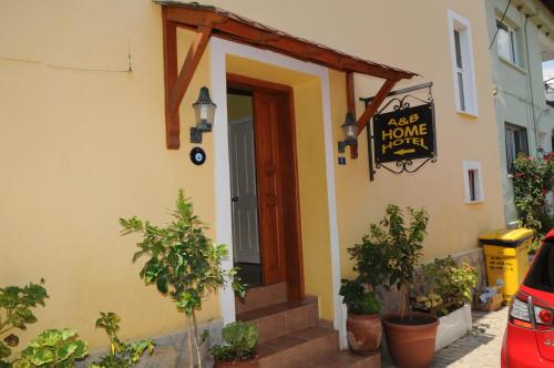 a door to a house with a sign on it at A&B Home Hotel in Göcek