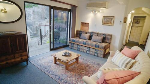 a living room with a couch and a coffee table at Coo-ee 9 in Herolds Bay