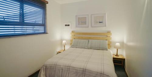 1 dormitorio pequeño con 1 cama y 2 lámparas en Coo-ee 9, en Herolds Bay
