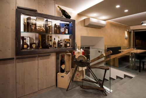 a room with a bar with a table and some bottles at Hotel Ambra in Clusone