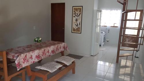 a dining room with a table and some chairs at Loft Holambra in Holambra