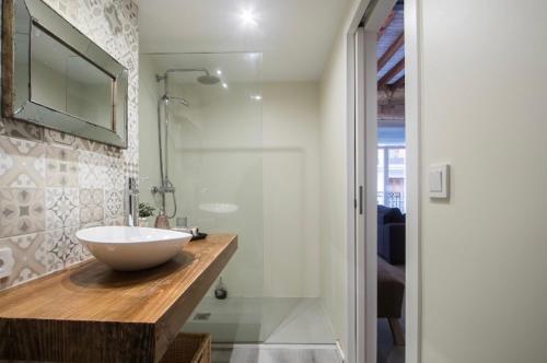 a bathroom with a bowl sink and a shower at Beautiful loft in old town in Alicante