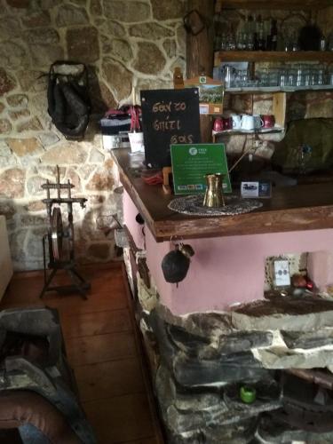 a stone wall with a counter with a laptop on it at Yono's Traditional House in Ano Ravenia