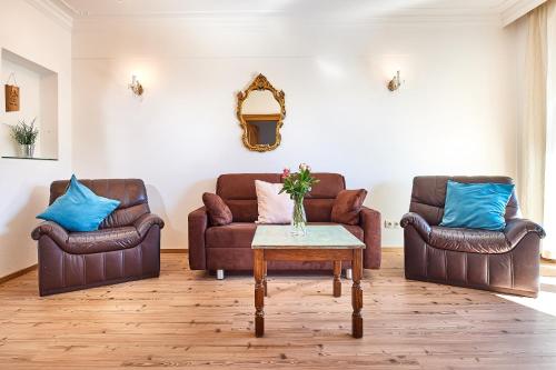 a living room with two couches and a table at Apartments Radstadt in Radstadt