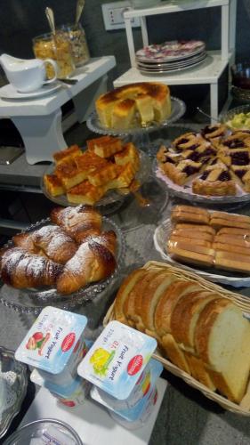 a bunch of different types of bread and pastries at Bed & Breakfast Cascina Beatrice in Rodello