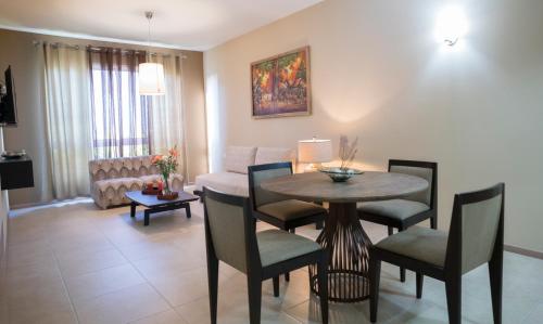 a living room with a dining room table and chairs at Costa Esmeralda Village in Palm-Eagle Beach