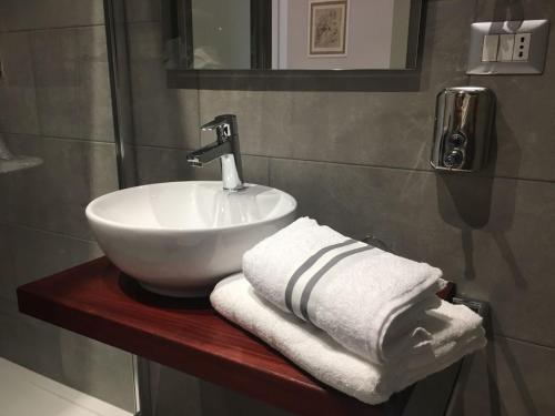 a bathroom with a sink and towels on a counter at Interno 1 Ciampino Roma Luxury Apartment con balcone in Ciampino